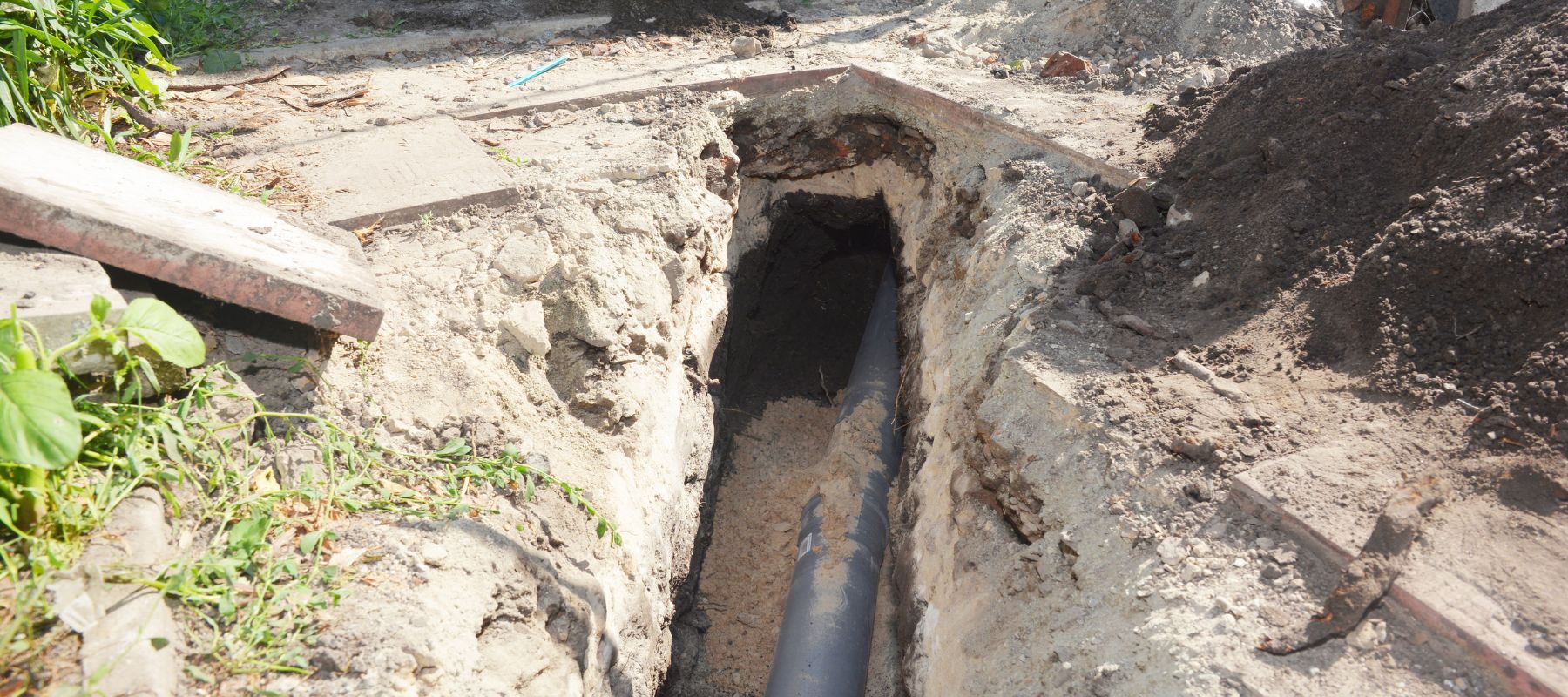 black plastic pipe running underground